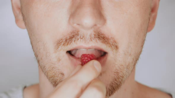 Close Up Face Fair Man Eat Raspberries alt