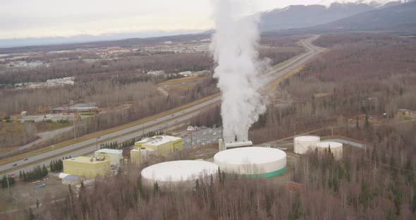 Helicopter aerial shot of sun setting over Los Angeles city skyline alt
