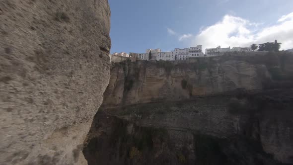 Unique aerial rounds steep cliff to reveal arch bridge over deep gorge alt