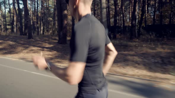 Running Man On Road Half Marathon. Triathlete Jogger Ready For Marathon And Hard Training. alt