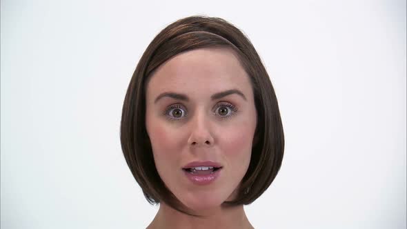 Close-up of a woman giving a surprised expression on a white background. alt