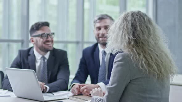 Businesspeople Joking in Meeting Room alt