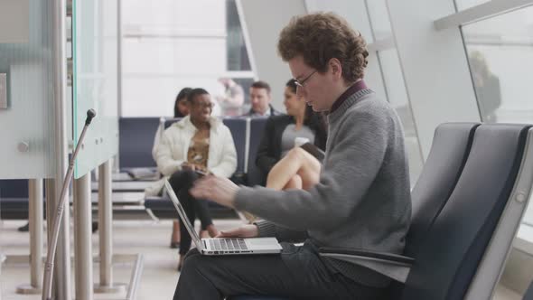 Man using laptop at airport