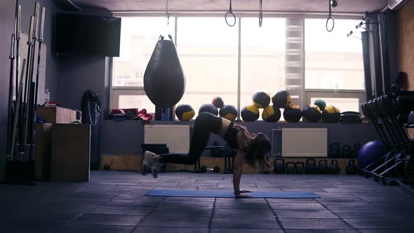Footage of a Sportive Brunette Girl Working Out at the Gym Jumping Into Plank on Floor Mat alt
