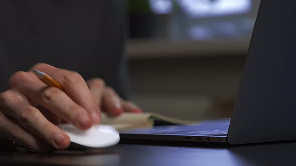 A Graphic Designer Draws a Prototype of an Icon Visual with a Pencil on Paper alt