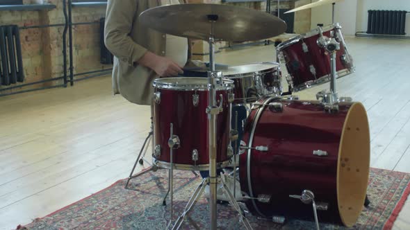 Mature Man Playing Drums in Loft Studio alt