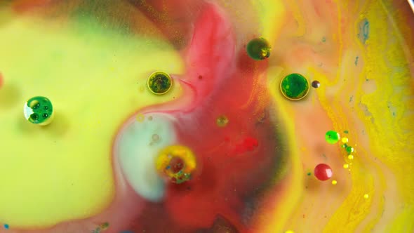 Colorful abstract bubbles and drops on the yellow and red water surface
