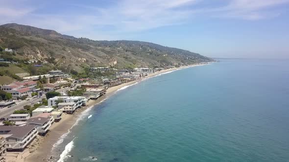 Slow motion Malibu Beach House on Highway One.Beautiful aerial view flight panorama overview drone alt