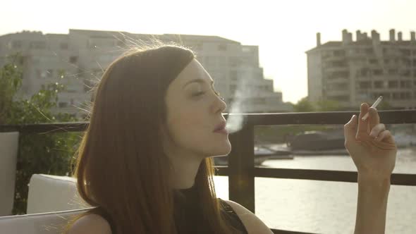 Woman enjoying cigarett outdoors, slow motion