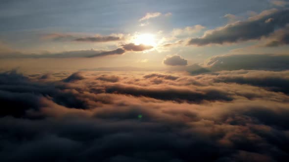 Aerial shot: Flying above Amazing Fluffy Clouds at Morning Time. alt