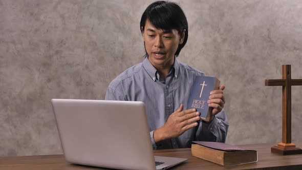 Young missionary is giving his audience the scriptural instruction through videoconferencing. alt