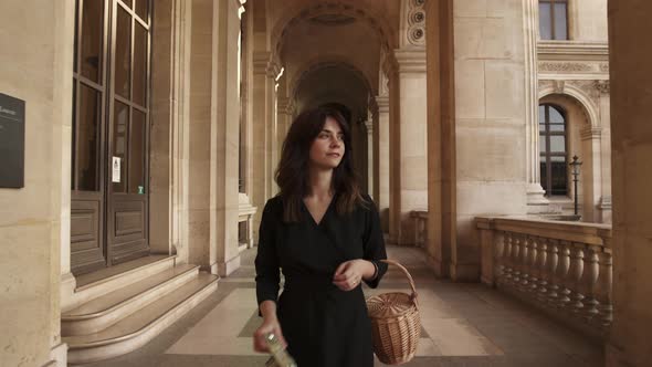 Woman in Black Dress Making a Photo Walking Outside Louvre Museum