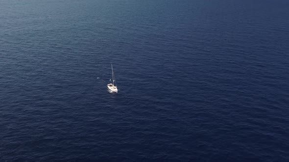 Aerial View on White Sailing Yacht Floating Across Mediterranean Sea. Lipari Islands. Sicily, Italy alt