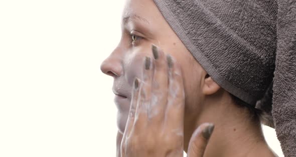 Closeup of Young Caucasian Woman Washing Cleansing Face with Organic Foamy Cleanser