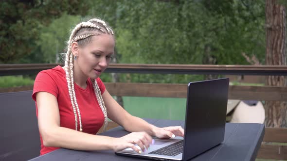 Woman with Laptop Emotionally Rejoices at Success alt