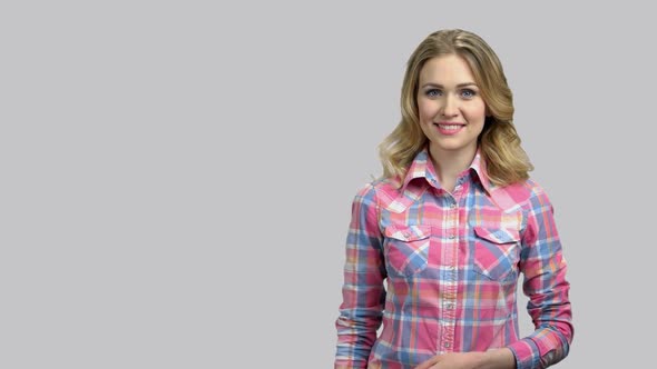 Happy Young Girl Showing Copyspace with Her Left Palm Up alt