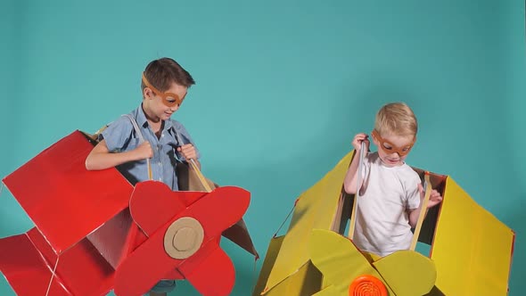Cheerful Kids Wearing Airplane Boxes alt