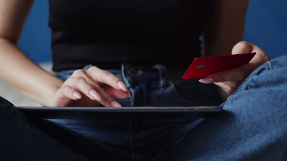 Women's Hands Pay for Purchase Using Bank Card and Using Digital Tablet Closeup alt