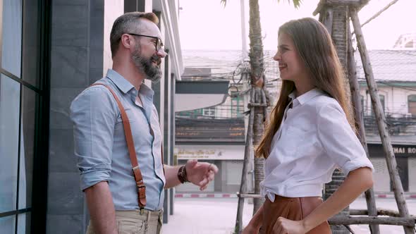young couple conversing outdoors in city park for sharing ideas alt