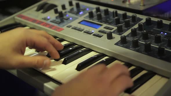 Musician Playing Synthesizer at Concert, Expensive Sound Equipment, Music alt