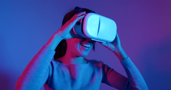 Woman looking though VR device with red and blue light