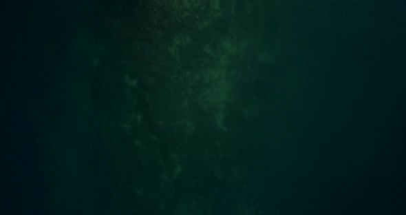 Birds eye view of man made island in Montenegro. Clear, calm water and a sunny day aerial footage alt