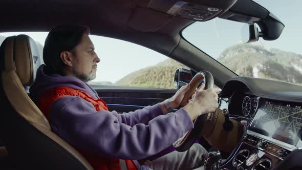 The driver driving the car looks at his wristwatch