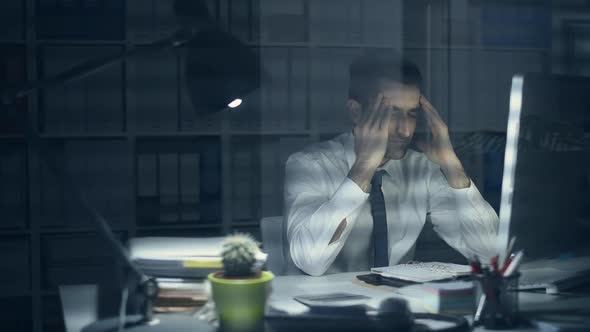 Tired businessman working late at night