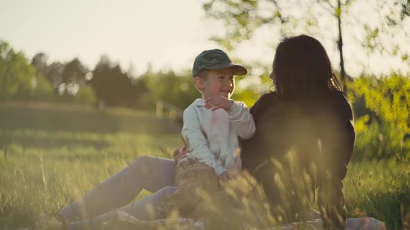 Mom and Son are Happy to Play Together in Nature alt