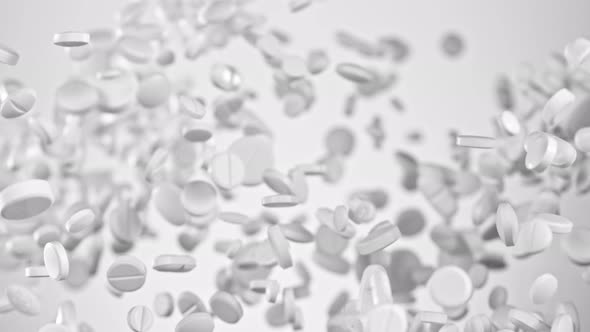 Super Slow Motion Shot of Flying White Pills on Gradient Grey Background at 1000Fps. alt