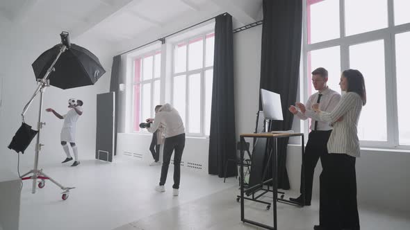 Behindthescenes Photo Shoot A Photographer in a Photo Studio Uses a Flash for Photos of a Black alt