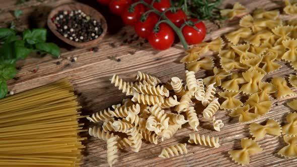 Super Slow Motion Shot of Fresh Pasta Falling on Italian Decorated Wooden Table at 1000Fps alt