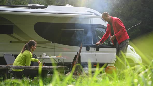 Young Couple Having Great Time on a Camping with Motorhome alt
