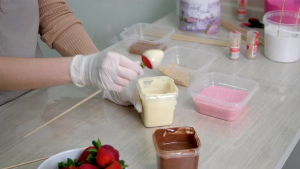 The Girl Cooks Strawberries in White Chocolate and Waffle Shavings