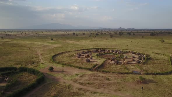  Aerial of a remote African village in a wide rural Savannah, Kidepo valley, Uganda, Africa. 4K alt