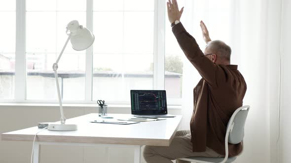man rejoices at his success in the stock market alt