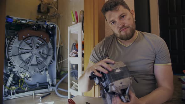 Middleaged Man Tired of Repairing His Home Washing Machine on His Own