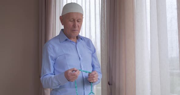 An Old Man with Rosary Beads Praying