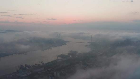 Drone View of the City Bay and Big Bridge Covered with Fog at Sunset alt
