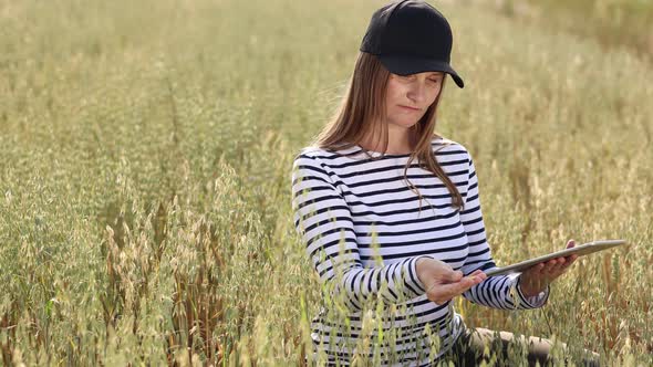 Modern technologies in agriculture, business woman farmer with computer tablet in her hands works 