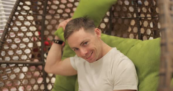 Man Sways on Swing and Relaxes