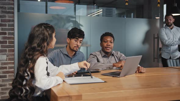 Multiracial Colleagues Sit in Office at Table Discuss Project Ideas Angry Disgruntled Boss Scolds alt