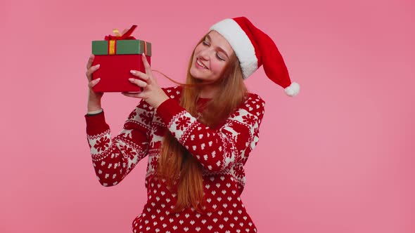 Funny Girl Wears New Year Sweater Deer Antlers Received Present Interested in What Inside Gift Box alt