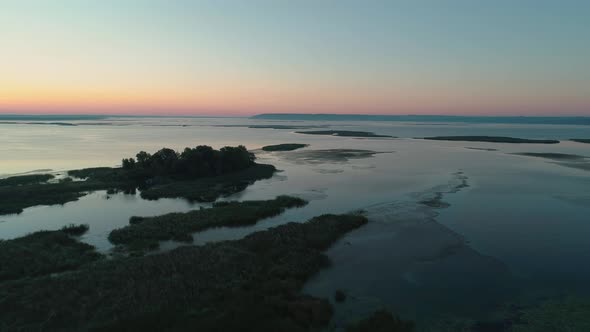 Aerial Drone Footage. Fly Over River with Islands at Sunrise