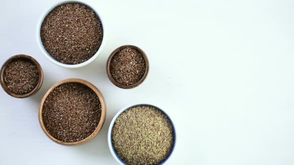 Flax seeds on painted wood board alt