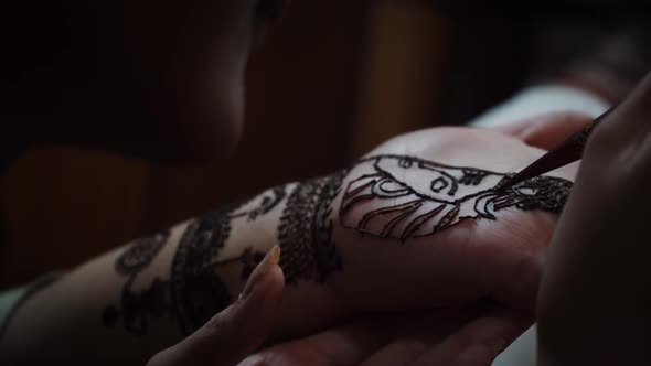 Woman Mehendi Artist Painting Henna On The Hand In Agra City, India. - High Angle Shot
