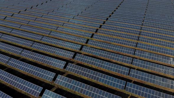 Solar Power Station. Solar Panels Stand in a Row in the Fields. Green Energy and Electrics