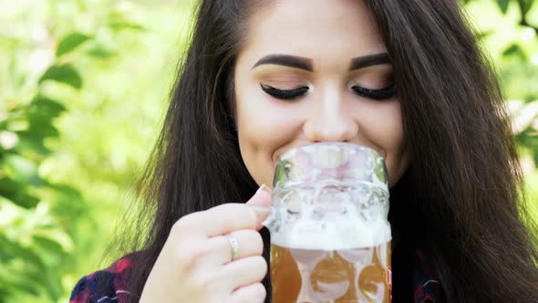 Portrait of Young Happy Beautiful Woman Which Drinks Beer From Glass, Quenches Thirst alt