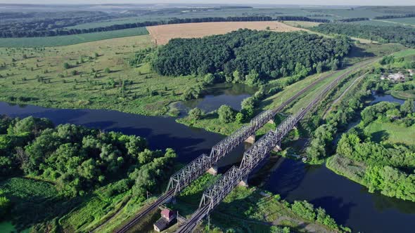 Train Bridge Crossing a River on a Bright Day alt