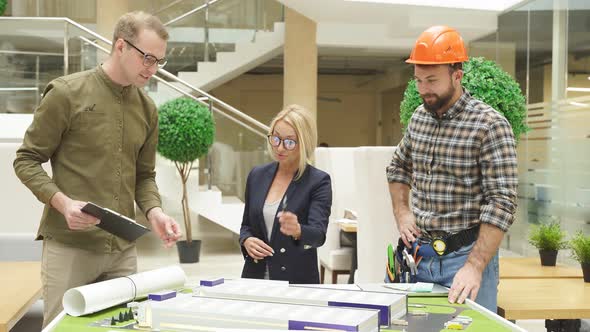 Engineers Coworking Office Discuss Building Complex Prototype Project alt